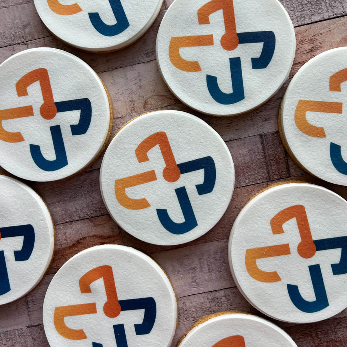 Cookies with a logo on a wooden surface