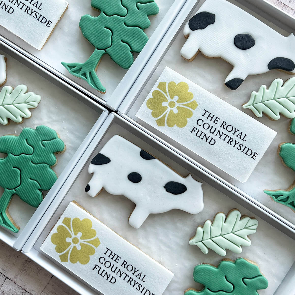 Decorative cookies with animal and leaf designs in a box, branded 'The Royal Countryside Fund'.