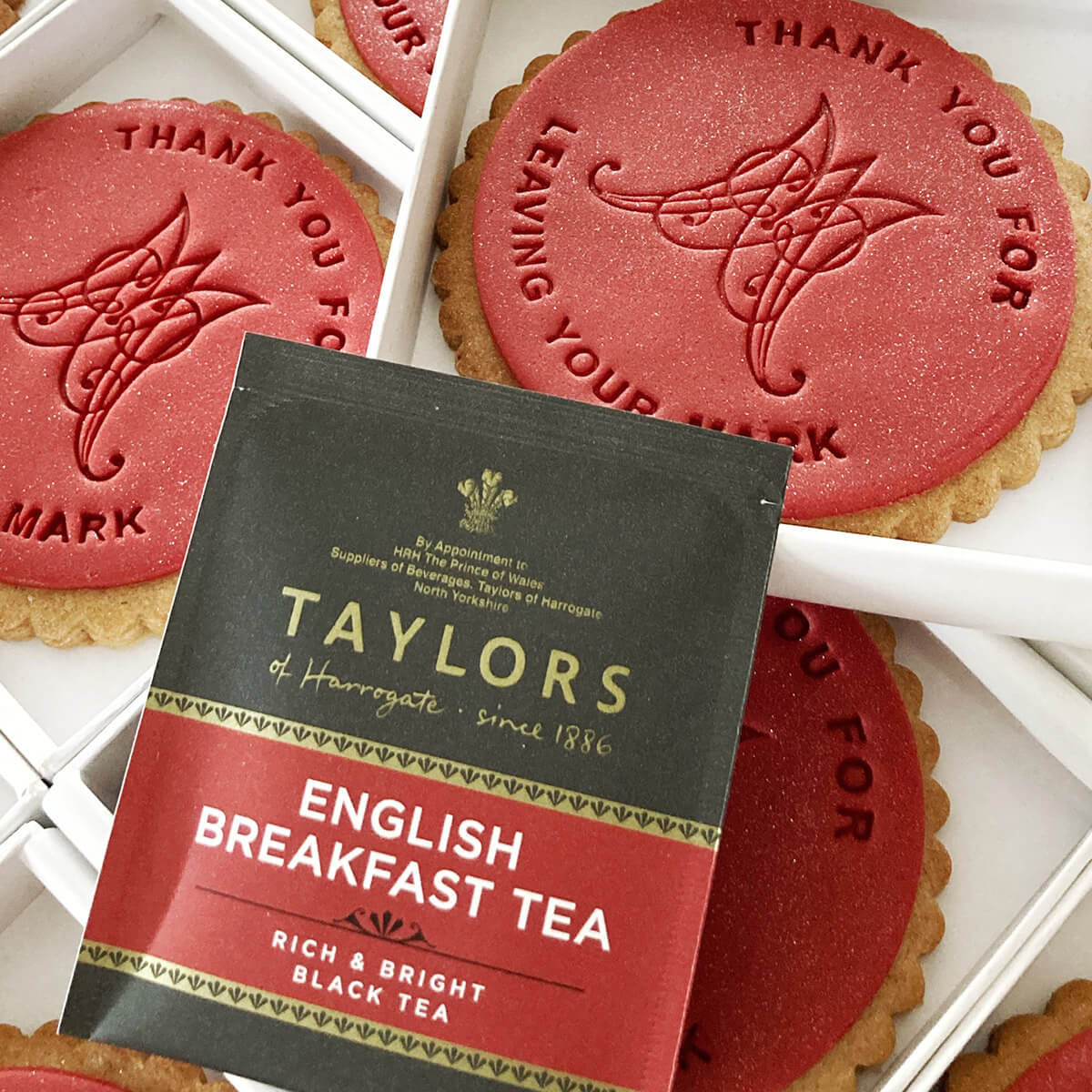 Taylors English Breakfast tea package with cookies in the background