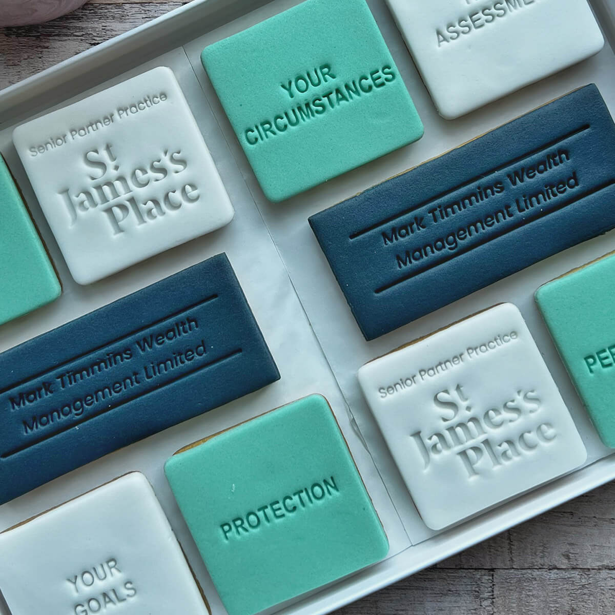 Set of branded soap bars with 'St James's Place' and 'Mark Timmins Wealth Management Limited' on a wooden surface.