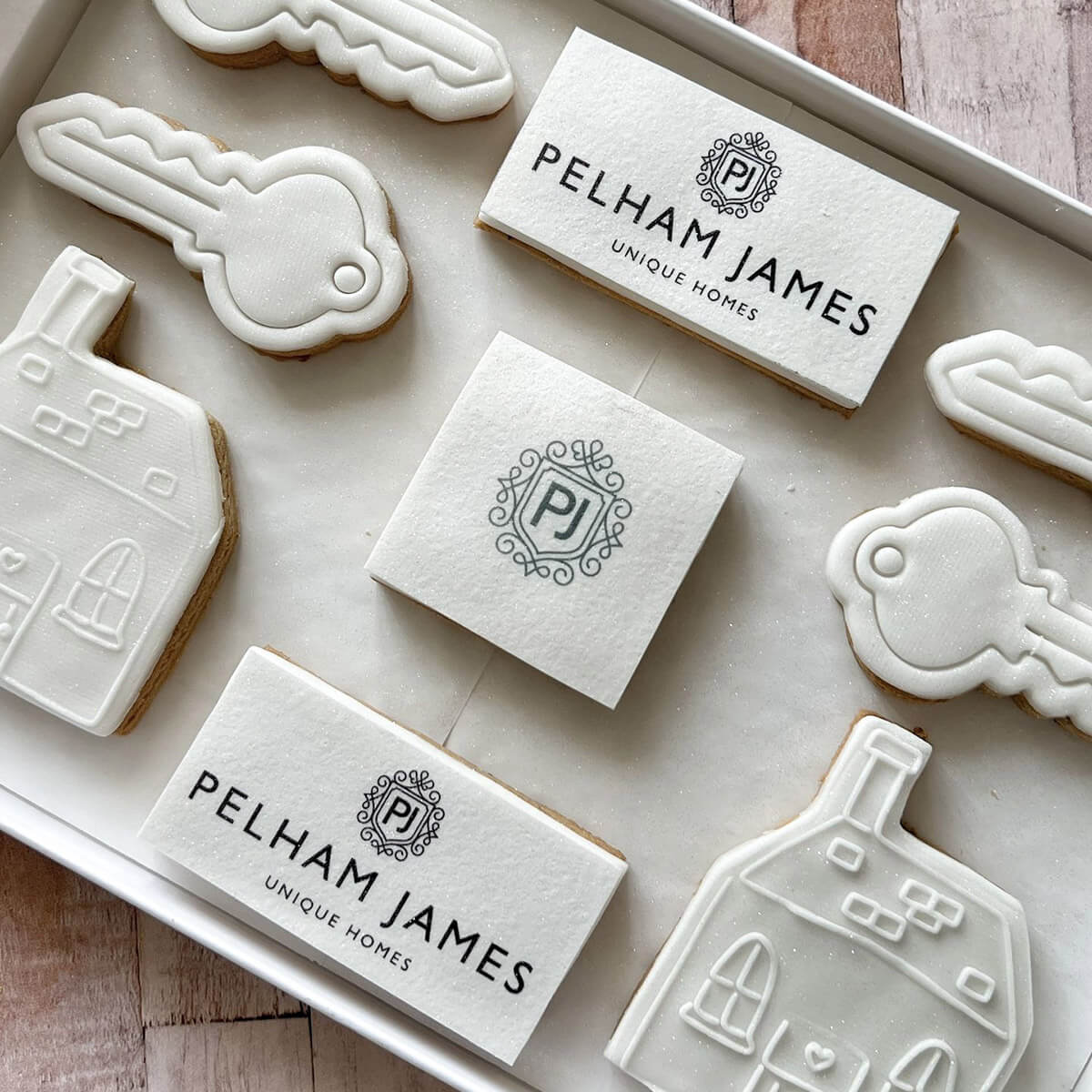 Decorative stamps with 'Pelham James' branding on a wooden surface