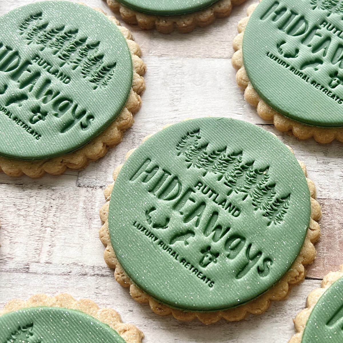 Cookies with 'Rutland Hideaways' branding on a wooden surface